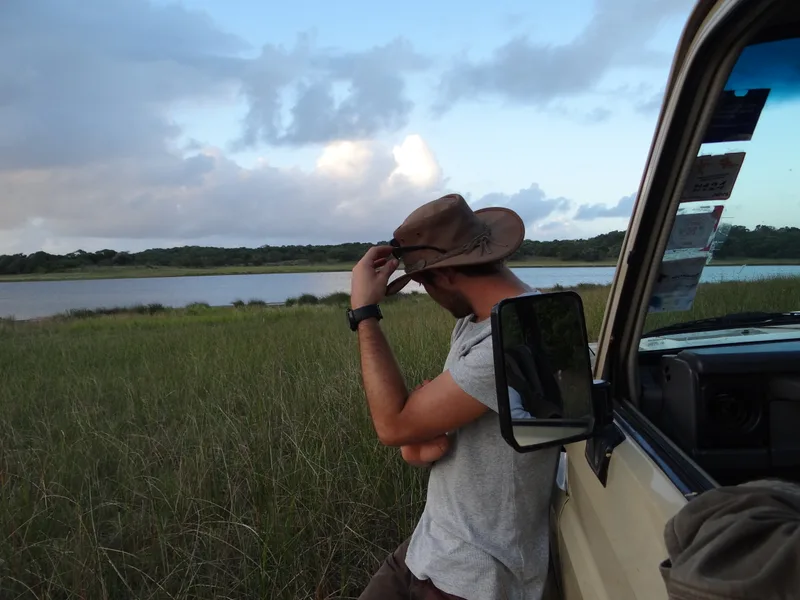 Mabeco guide beside expedition vehicle in the Mozambique wilderness